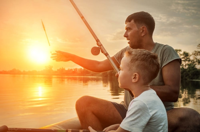 Father and sun fishing at sunrise.